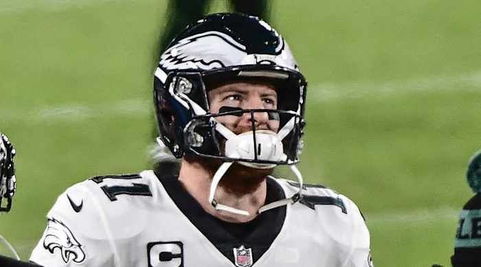 Philadelphia Eagles quarterback Carson Wentz (11) watches the game from the sidelines in the third quarter during the game against the Green Bay Packers at Lambeau Field.